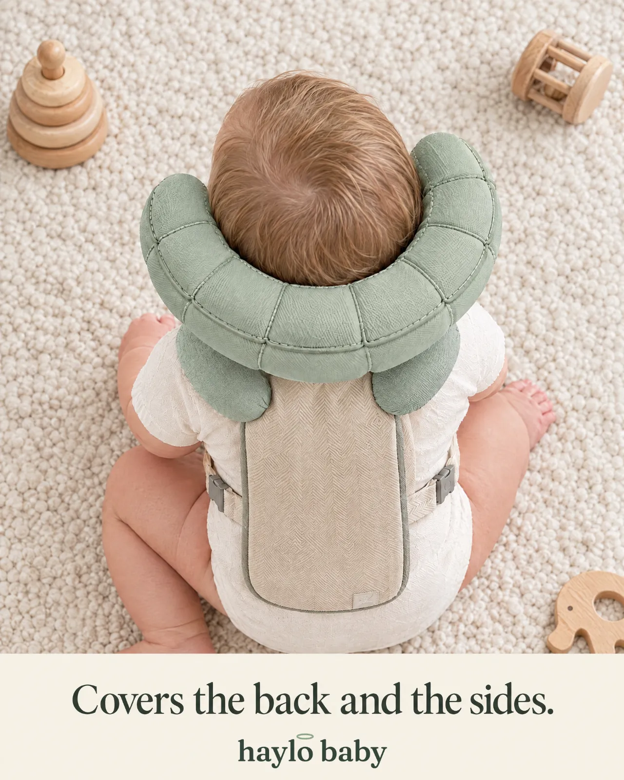 Top-down view of a seated baby wearing the Haylo Baby halo: covers the back and the sides