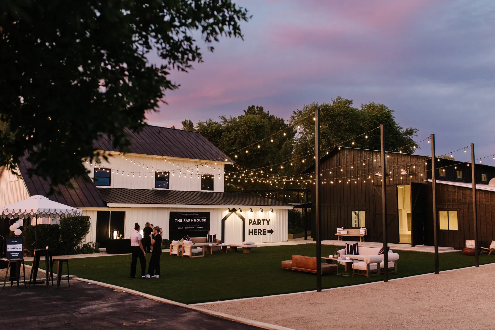 The Acre at dusk, with string lights over the courtyard