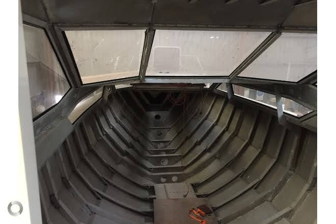 Raw aluminium hull interior — ribbed frame looking forward