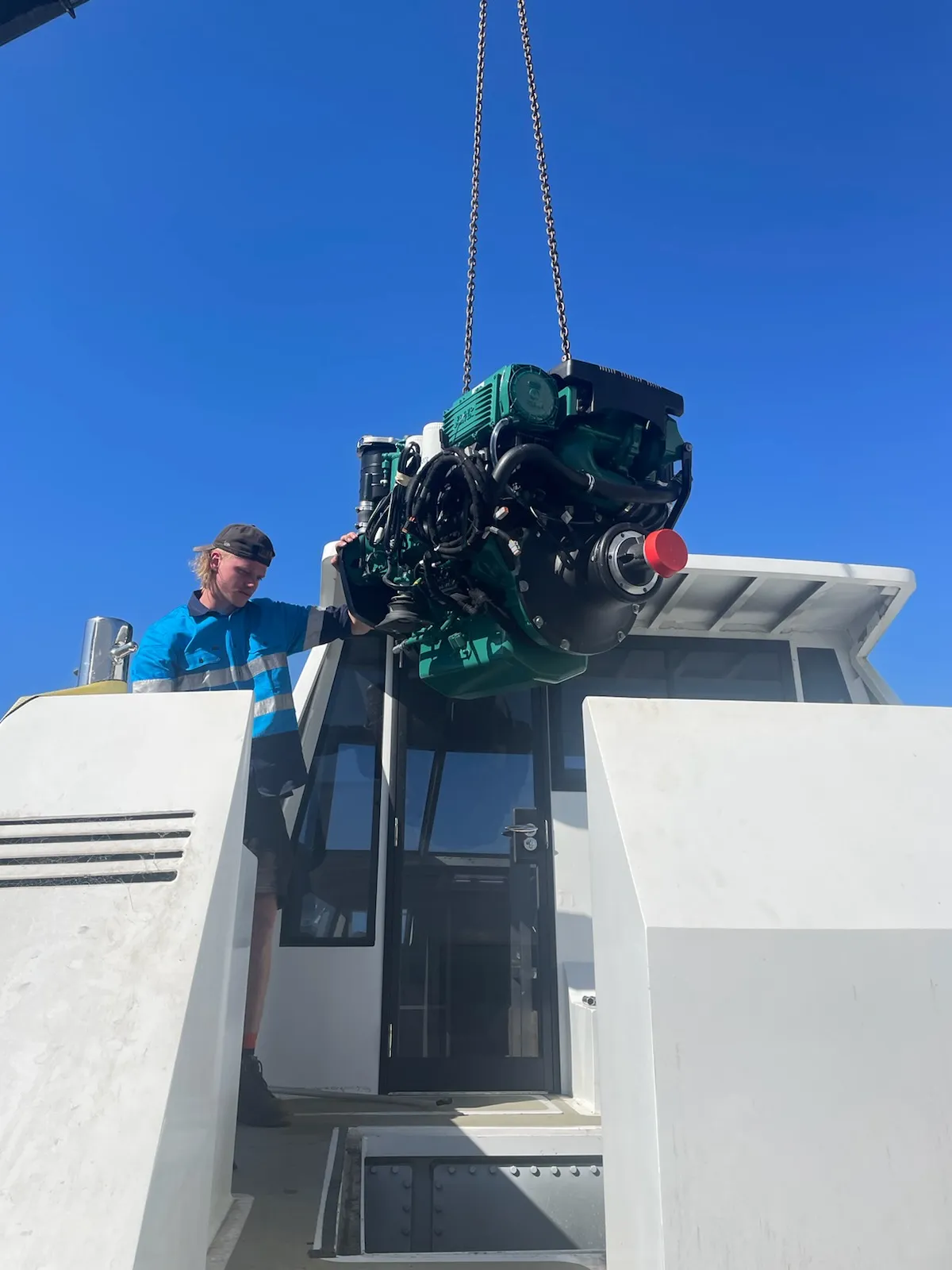 Engine being lowered into the boat