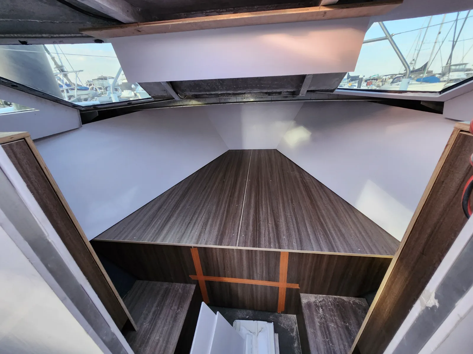 V-berth cabinetry taking shape — looking forward