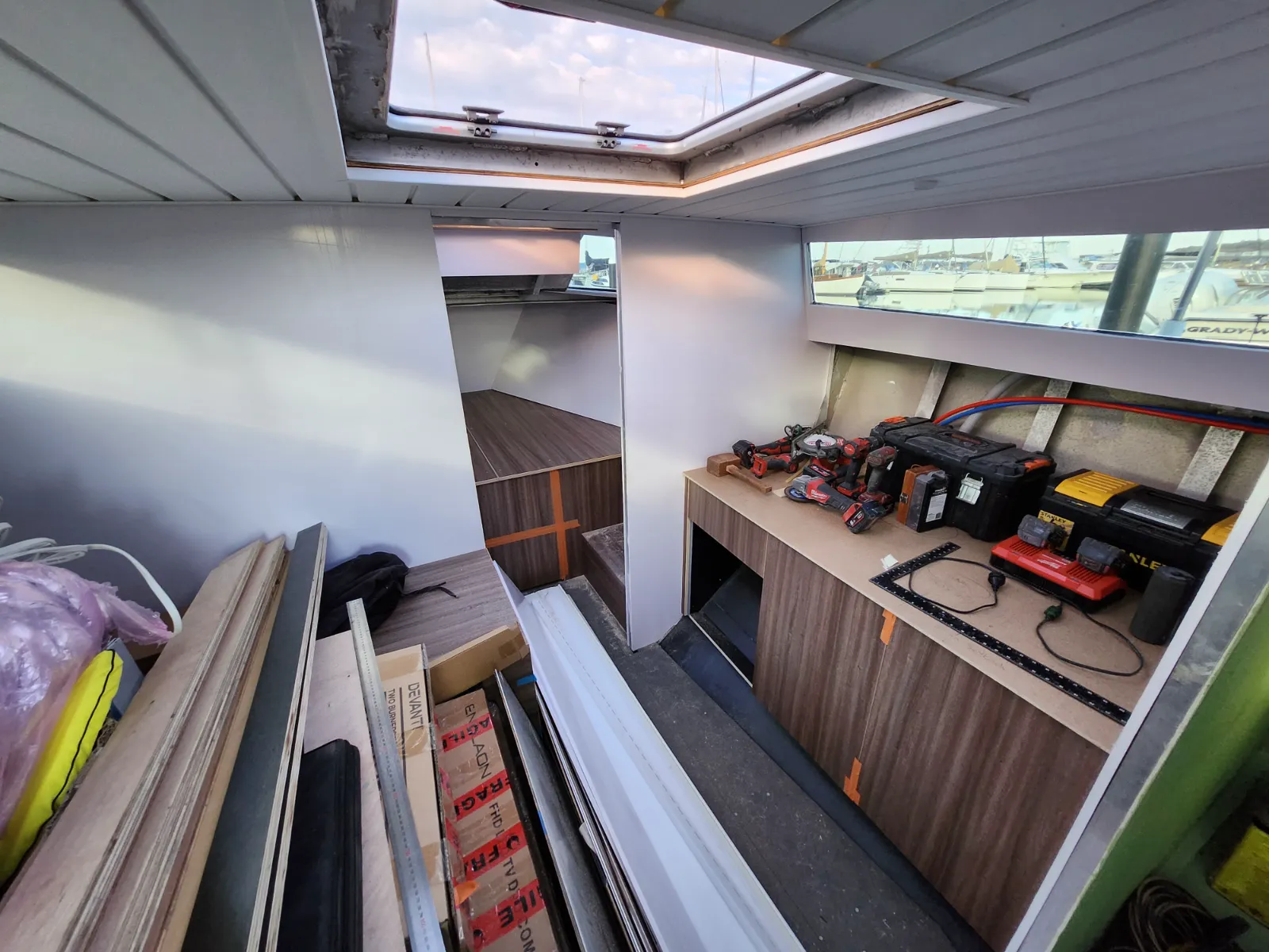 Mid-build interior — cabinetry carcasses and tools in place