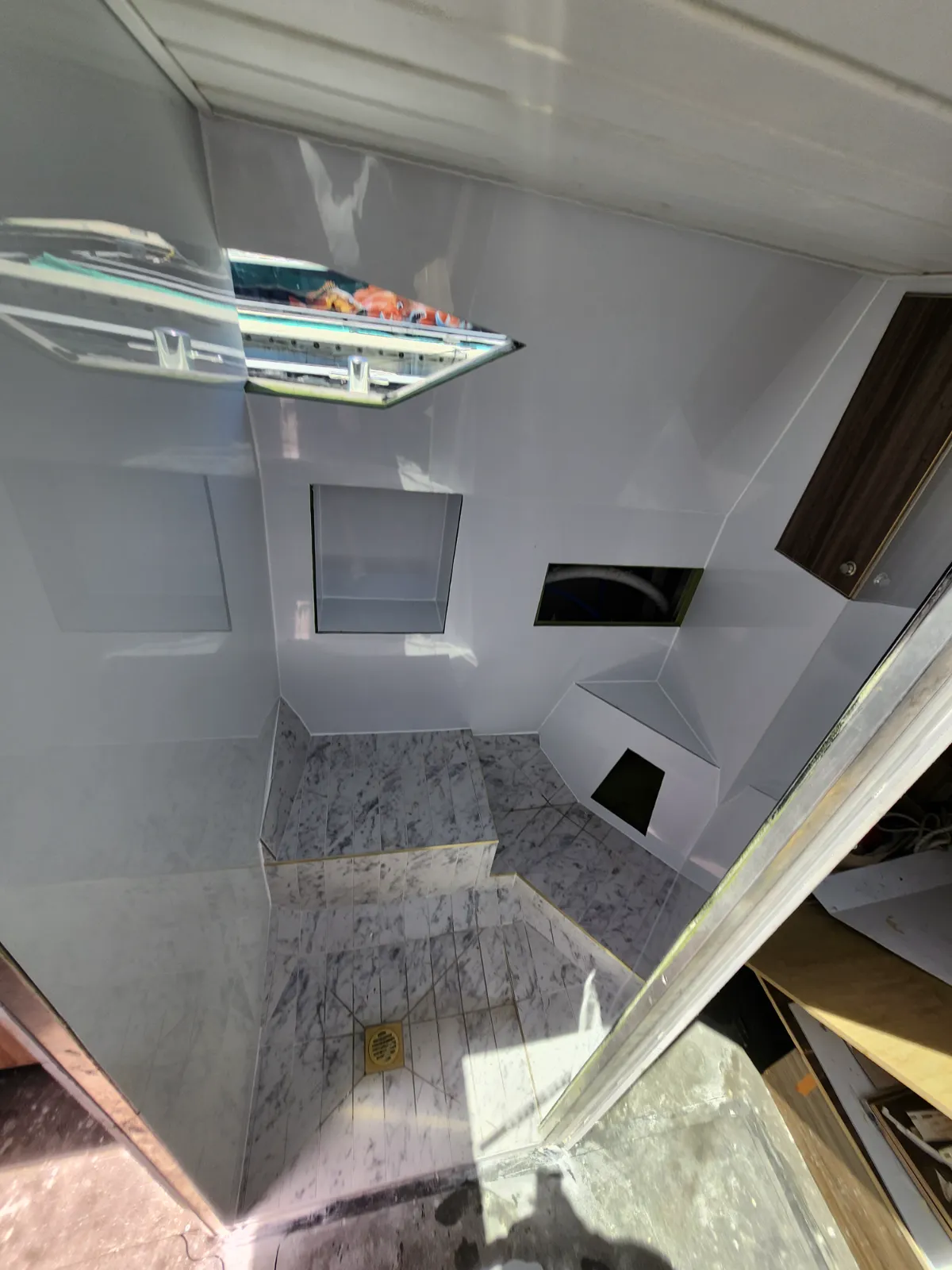 Head finished — high-gloss white panels, marble floor, gold fittings