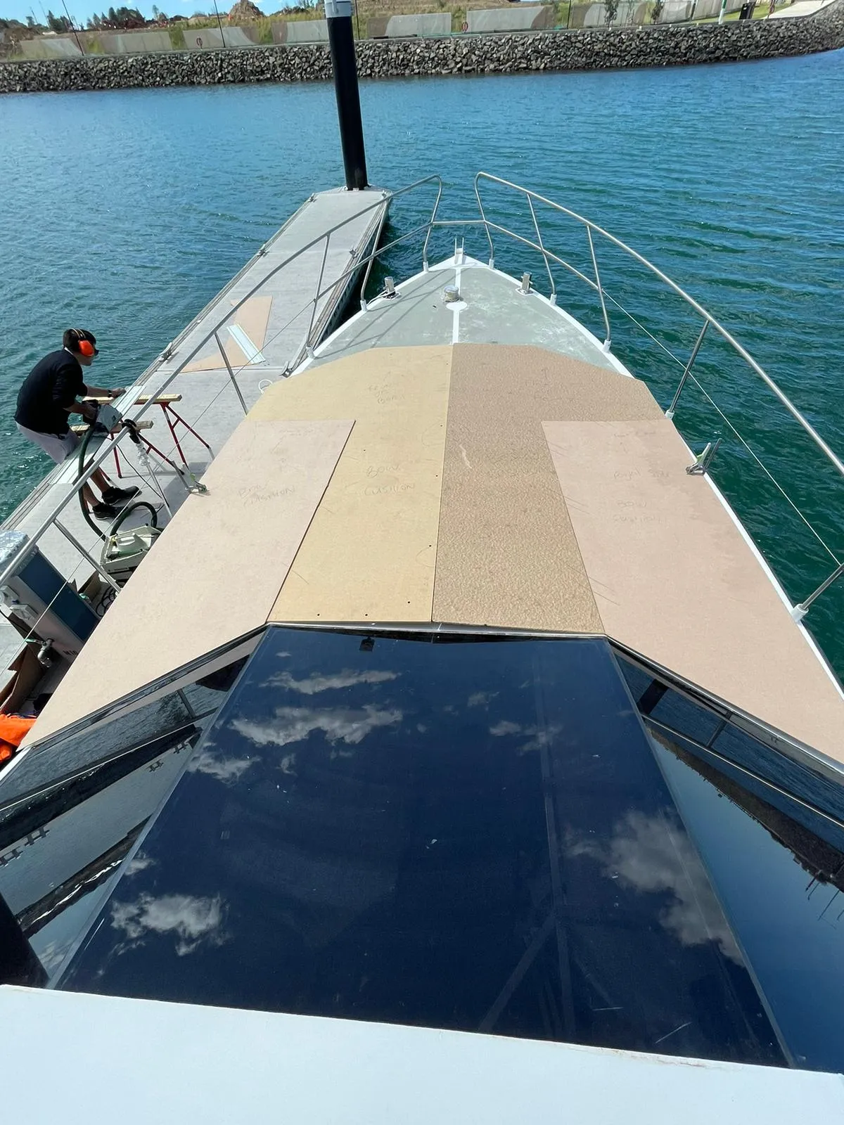 Deck cushion templates being cut on the foredeck