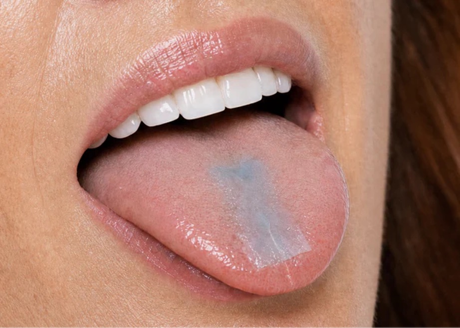Neuvera oral dissolving strip on a woman’s tongue post-workout