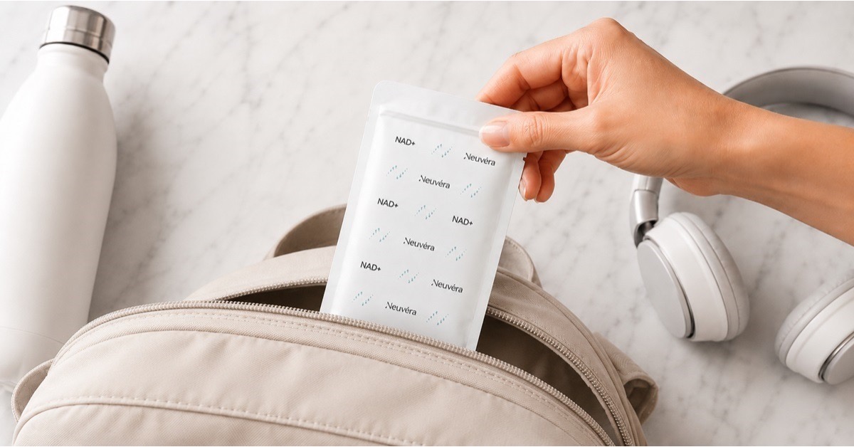 Hand placing a Neuvéra NAD+ strip pouch into a backpack, showing the strip's everyday portability