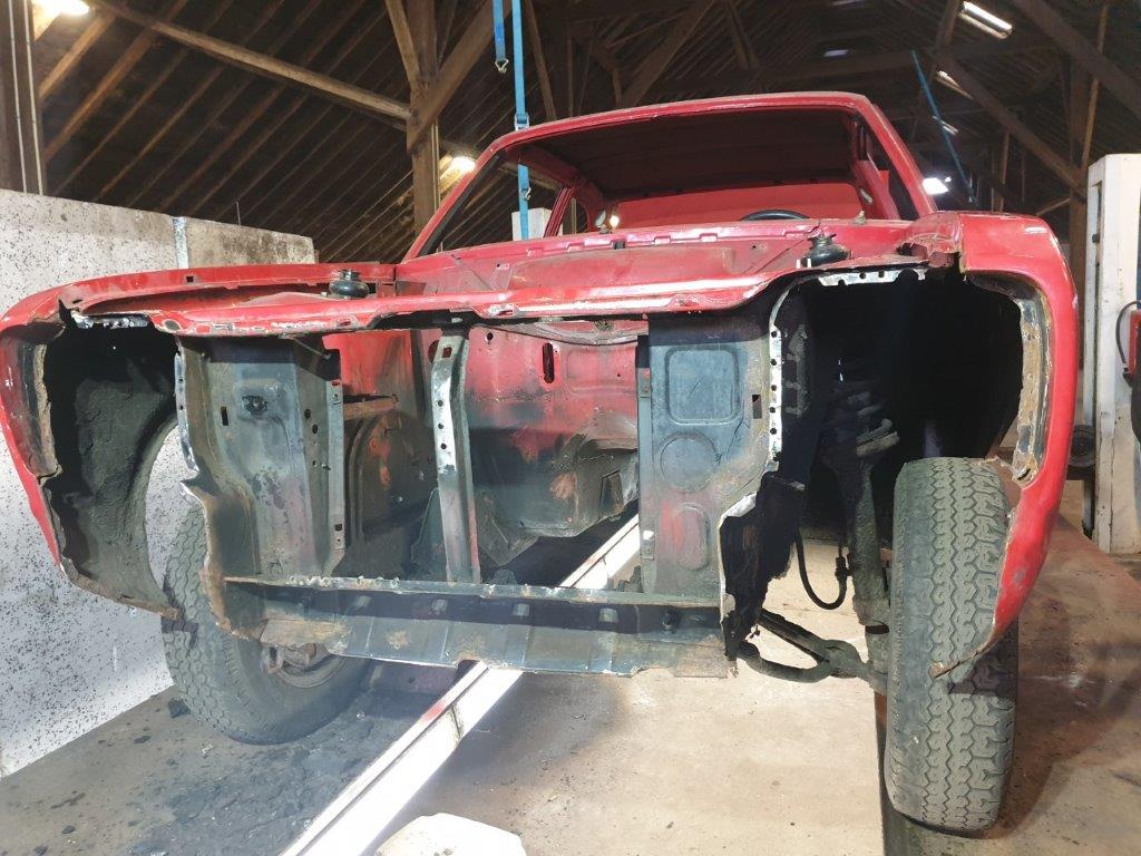 The red Escort shell stripped down in the workshop