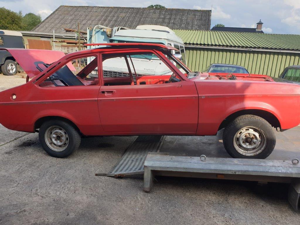 The red Ford Escort Mk2 on the trailer on arrival, side view