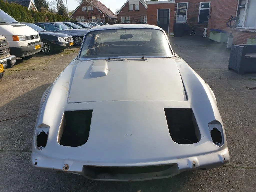 The Lotus Elan 2+2 from the front, bonnet in place and the headlamp pods open