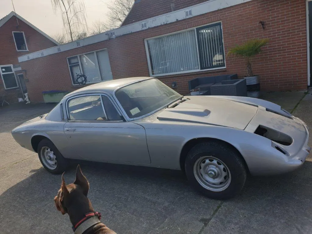 The silver Lotus Elan 2+2 as found, side view in the yard beside the workshop