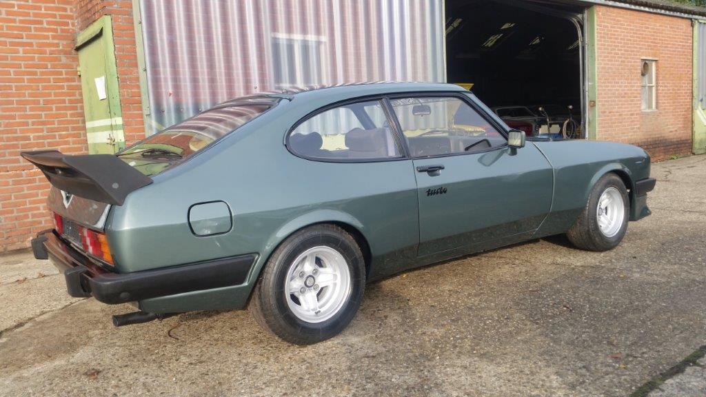 The Capri during reassembly, side view with the wide arches and wheels fitted