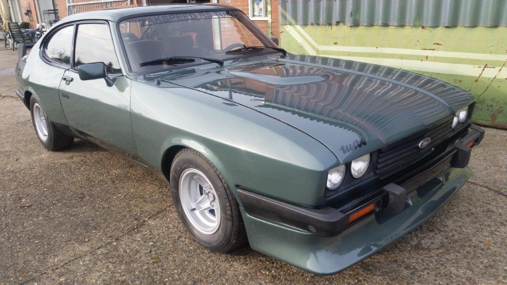 The Capri complete on its wheels outside the workshop, three-quarter view