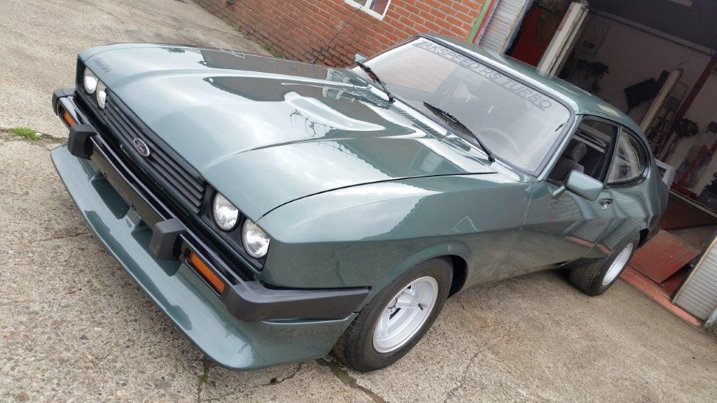 The painted Capri outside the workshop, front three-quarter view