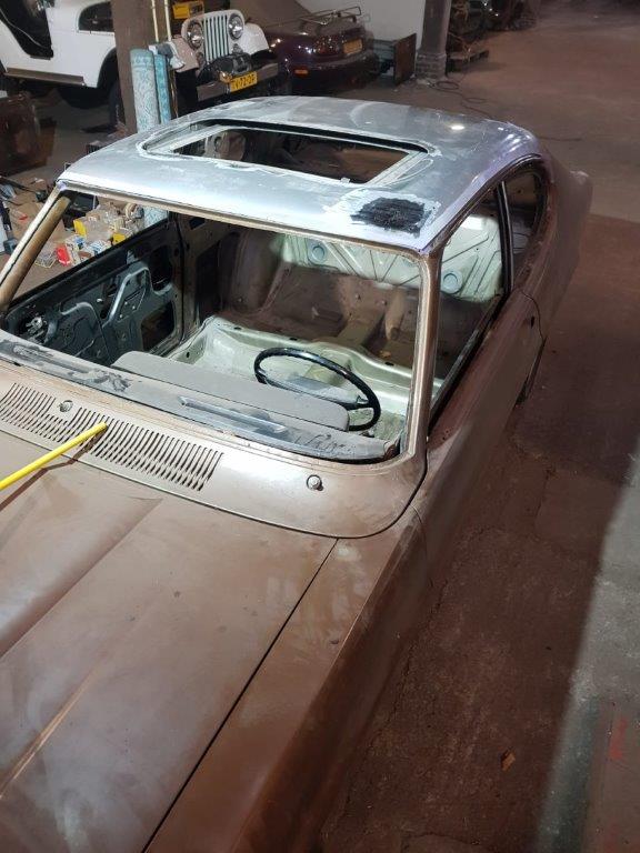 Bodywork on the roof and windscreen surround, the repaired area in primer
