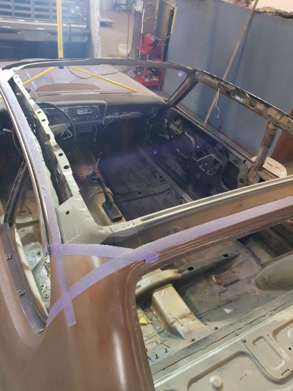 The Capri stripped down with the glass and trim removed, ready for bodywork