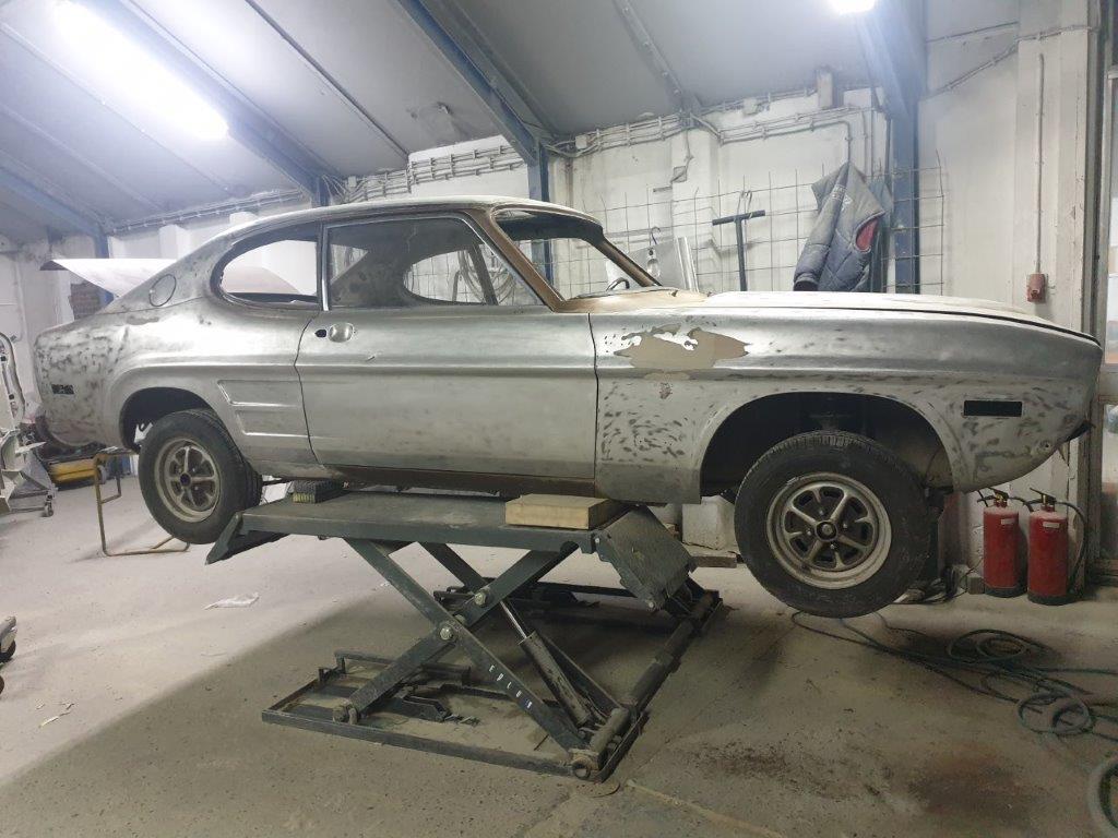 The Capri shell on the lift in the workshop during the bodywork stage