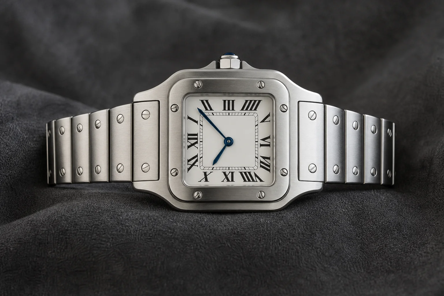 Square steel Cartier-style watch with Roman numeral dial on dark grey velvet