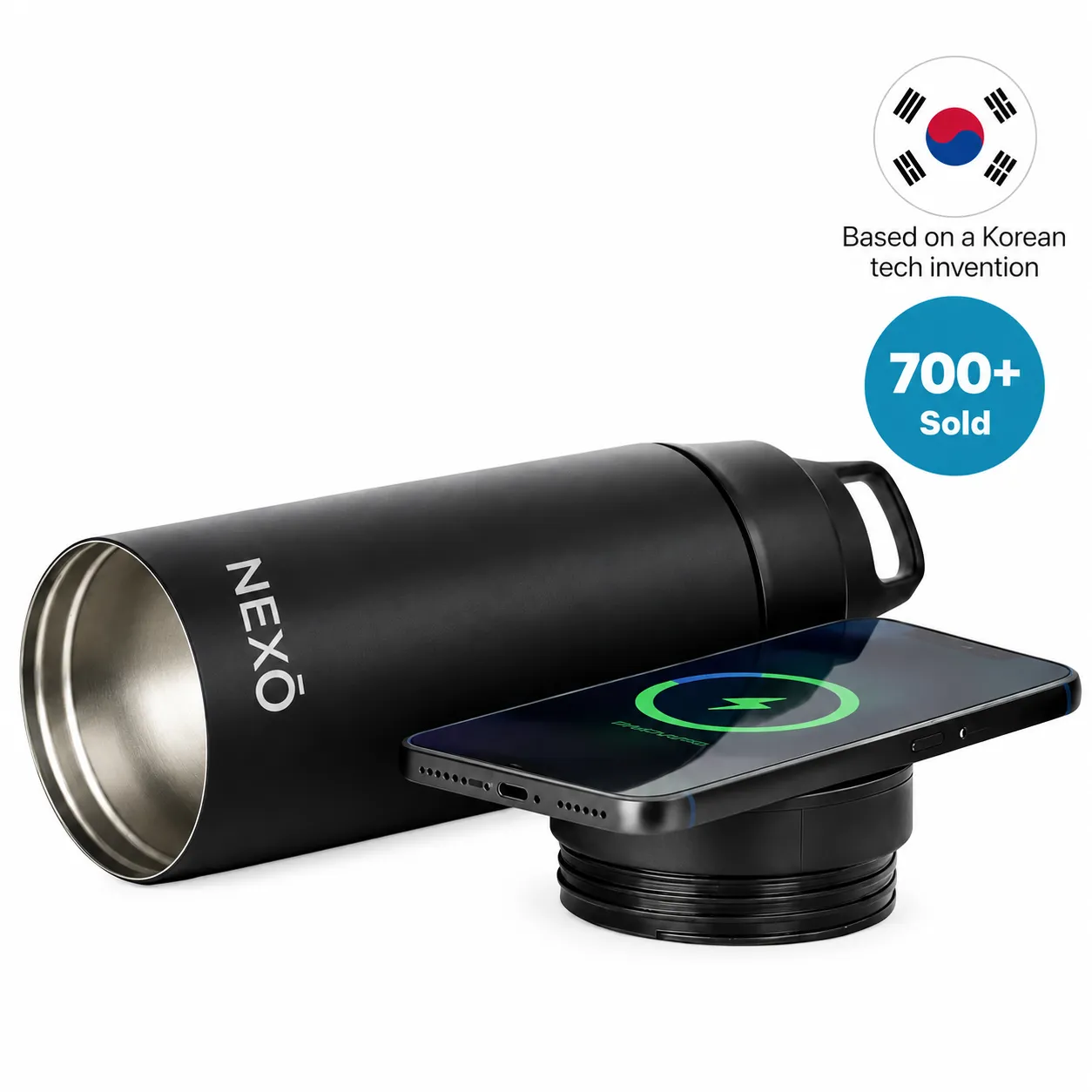 NEXŌ Power Bottle lying on its side beside its detached charging base, with a phone charging wirelessly on the base