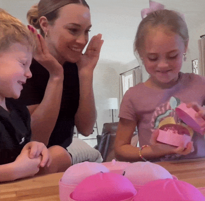 Kids opening a pink steamer basket to reveal a mystery squishy dumpling