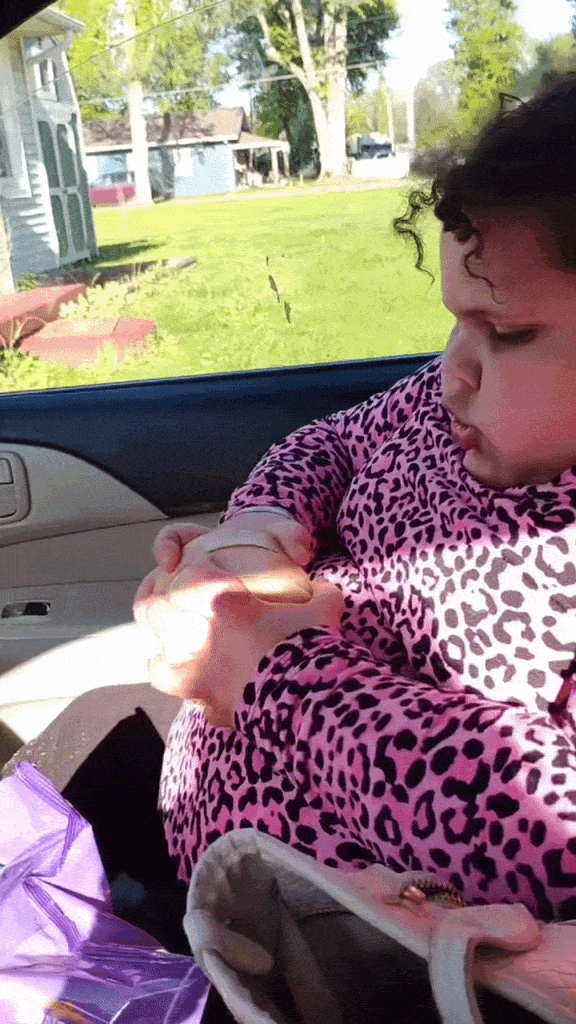Kid squishing a dumpling in the back seat of the car