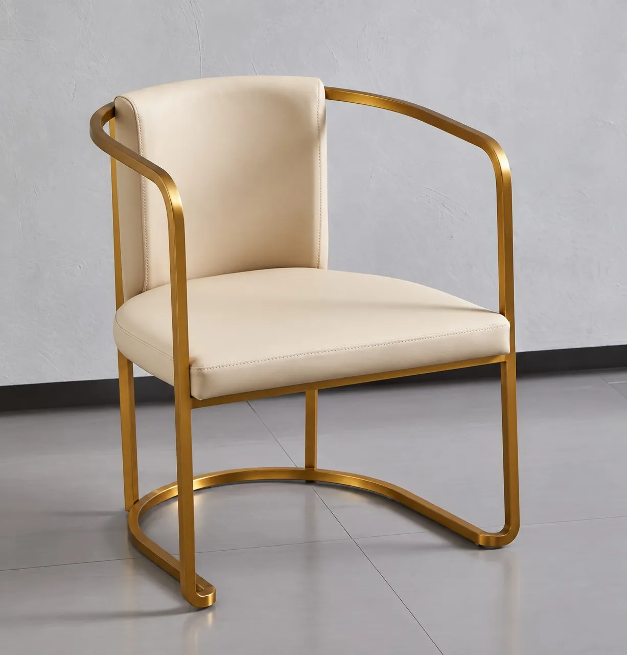 Cream upholstered chair with a curved bronze-toned frame