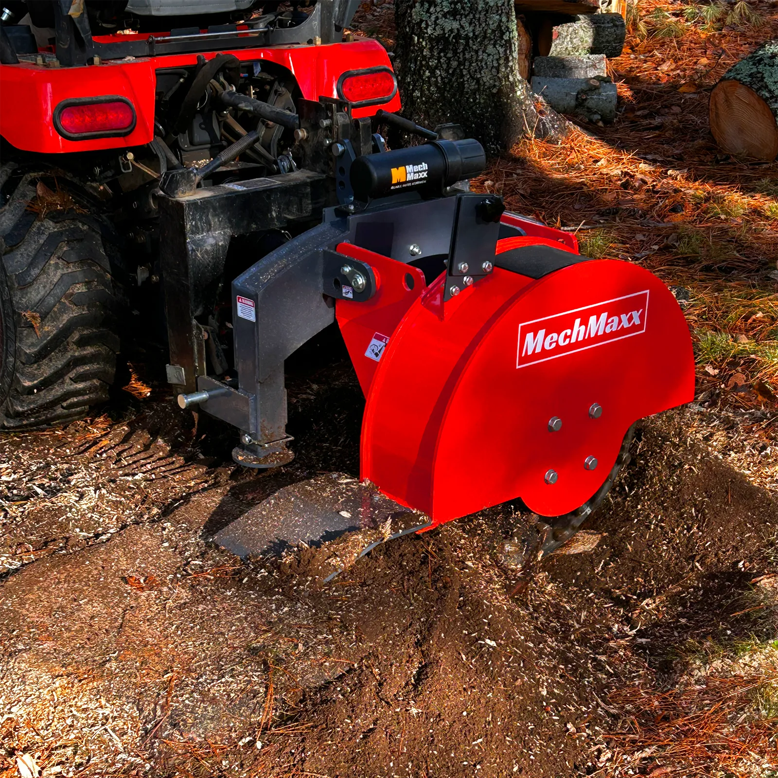 The SG24 cutting into a ground stump among red autumn leaves behind a red tractor