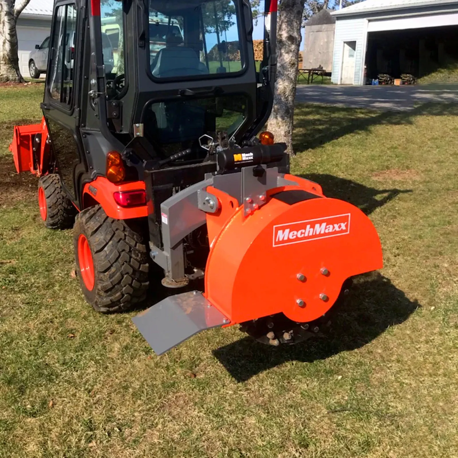 The SG24 mounted on a cab tractor parked on a lawn in front of a garage