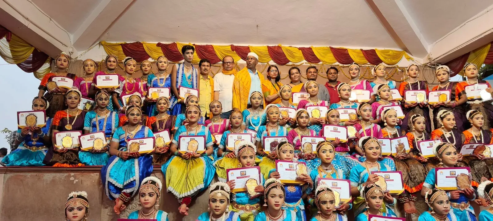 Large ensemble of young dancers celebrated with certificates and awards at an Uddharsha festival programme