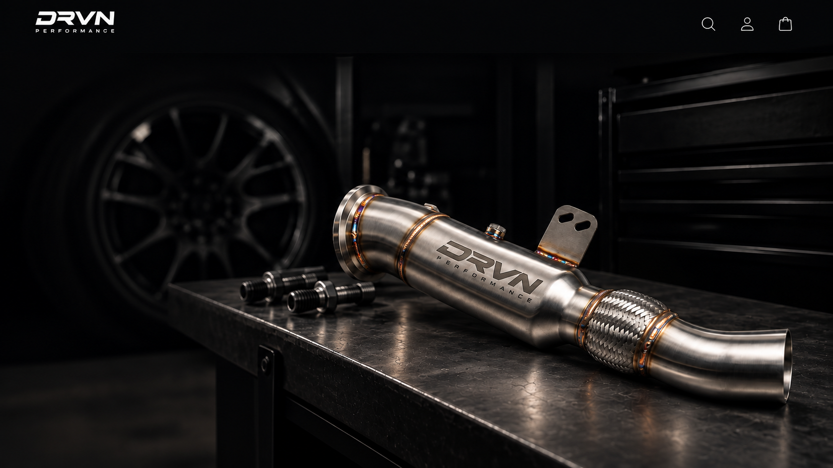 DRVN Performance stainless downpipe on workshop surface