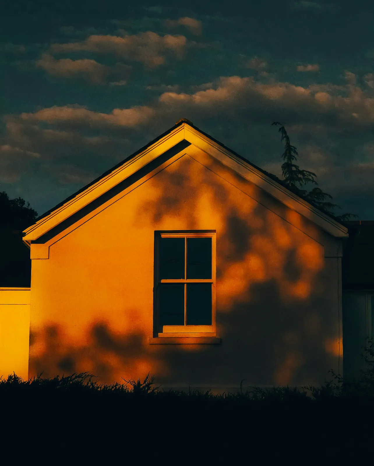 A house exterior washed in warm sunset light